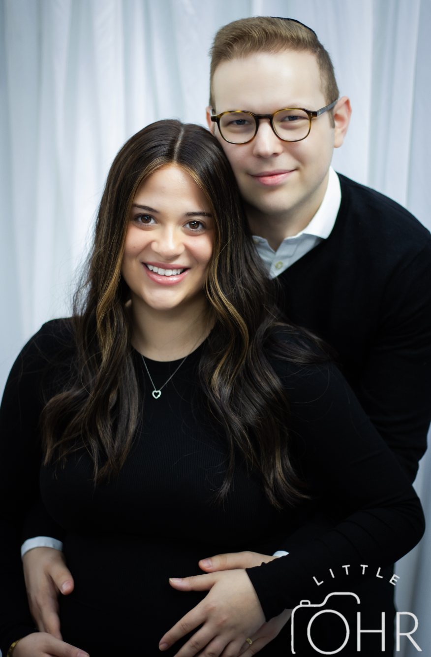 Expectant parents together in the studio, hands on the bump